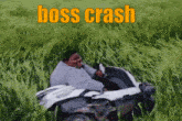 a man is sitting in a vehicle in a grassy field with the words boss crash below him