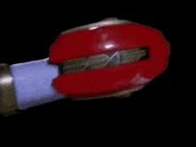 a close up of a person wearing a red helmet with a light on it .