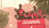 the word champions is on the red bus