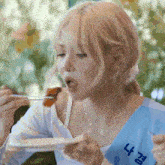 a woman wearing a blue sash with the letters n and k on it