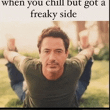 a man is laying on the grass with his arms outstretched and says when you chill but got a freaky side .