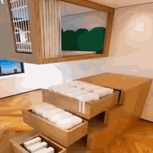 a room with a table and drawers filled with boxes and a mirror .