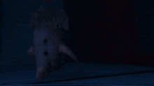 a ghostly figure is walking through a doorway at night