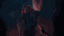 a man in a suit is holding a guitar in his hand .