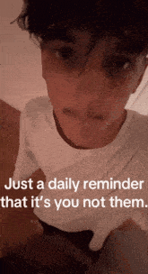 a man in a white shirt with the words just a daily reminder that it 's you not them below him