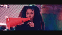 a woman with dreadlocks is blowing into a red cone