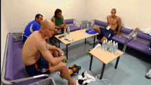 a man with the number 5 on his shorts sits on a table