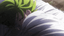 a person with green hair is sleeping on a white blanket