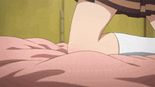 a person laying on a bed with a pink blanket on it