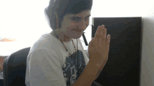 a young man wearing headphones and a shirt that says ' a ' on it