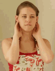 a woman wearing an apron with foxes on it adjusts her ears