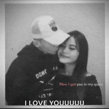 a black and white photo of a man kissing a woman on the cheek with the caption i love youuuuu