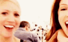 two women are standing next to each other with their mouths open .