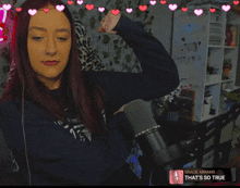 a woman stands in front of a microphone with hearts around her and the words gracie abrams that 's so true at the bottom