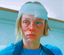 a woman with a bandage on her head is wearing a blue shirt and apron