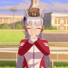a girl in a red and white jacket is covering her mouth with her hands