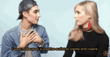 a man and a woman are talking and the man is wearing makeup as a creative outlet to create and inspire