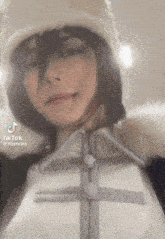 a tiktok video of a person wearing a hat and a jacket