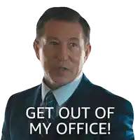 a man in a suit and tie is pointing at the camera and says get out of my office