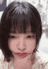 a girl with short hair is making a funny face