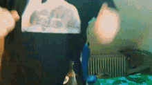 a person in a black shirt is standing in a room with a bottle of beer .