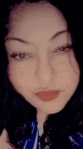 a close up of a woman 's face with a striped shirt