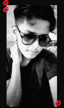 a young man wearing sunglasses and a black shirt