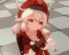 a girl in a red hat is holding a stuffed animal and a heart .