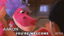 a cartoon dragon says " aaron you 're welcome " in front of a man