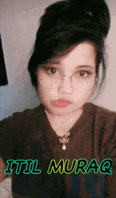 a girl with glasses and the name itil muraq on the bottom right