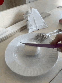 a white plate with a knife and fork on it