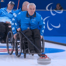 Pushing The Curling Stone Wheelchair Curling GIF - Pushing The Curling Stone Wheelchair Curling Andrei Koitmae GIFs
