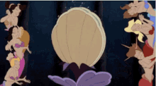 a group of mermaids are standing around a pearl in a cartoon .