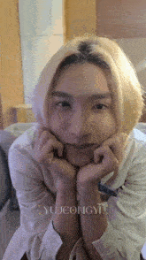 a close up of a person 's face with the name yujeongyi written on the bottom