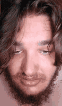 a man with a beard has his eyes closed