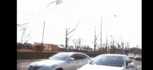 a couple of cars are parked on the side of a road .