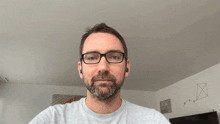 a man with glasses and a beard is talking