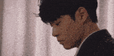 a close up of a man 's face in a suit and tie