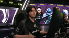 a man wearing headphones and a shirt that says heretics