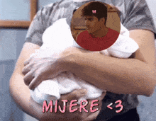 a man holding a baby with the words mijere < 3 written in pink