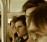 a man is talking on a cell phone while a woman looks on
