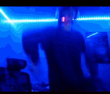 a blurry picture of a man wearing headphones in a dark room