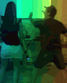 two people are dancing in front of a green screen