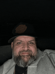 a man with a beard is wearing a hat that says ruthless