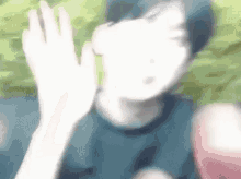 a blurry picture of a person waving their hand in the air .
