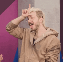 a man with blonde hair and glasses is making a funny face
