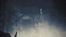 a person standing on top of a rocky cliff in the fog