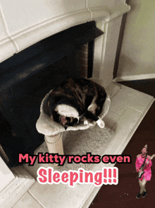 a cat sleeping on a cat tree next to a fireplace with the caption " my kitty rocks even sleeping "