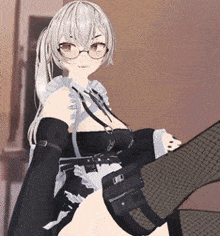 a girl with glasses is sitting on a bed with her legs crossed