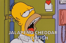 homer simpson from the simpsons is eating jalapeno cheddar sourdough with his mouth open .